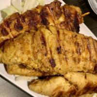 Satay · 4 pieces. Seasoned grilled chicken tenderloin on skewers. Served with peanut sauce and cucum...