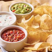 Classic Dip Trio · Freshly made white corn tortilla chips served with our chipotle lime salsa, melty white ques...