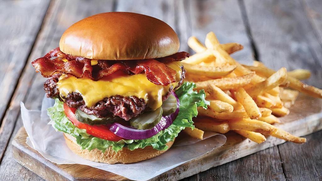 Classic Bacon Cheeseburger · Go old school with our handcrafted all-beef patty topped with your choice of two cheese slices and two strips of Applewood-smoked bacon. Served with lettuce, tomato, onion and pickles on a Brioche bun. Served with fries.