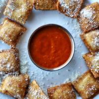 Toasted Raviolis · Noodle pockets filled with delicious cheese and toasted to a golden brown. Served with marin...