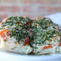 Tomato Bread · Crisp Italian bread topped with tomatoes, garlic, fresh basil and Parmesan cheese.