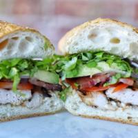 Chicken Club · Grilled chicken breast, artisanal bacon, avocado, tomatoes, red onions, lettuce and mayo.