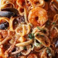 Pasta Puttanesca · Linguine served with a tomato based sauce, tender calamari, jumbo shrimp, bay scallops, Ital...