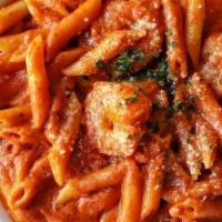 Shrimp Arrabiata · Shrimp sauteed in a spicy tomato sauce with a touch of cream, served over penne, topped with...