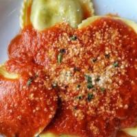 Spinach Ravioli · Ravioli filled with spinach. Topped with marinara sauce.