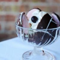 Spumoni · Bomba-strawberry, pistachio and chocolate gelato coated with chocolate and drizzled with whi...