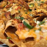 Cantina Nachos · Peruvian grilled diced chicken, queso, mixed cheese, purée white beans, diced onion, tomato ...