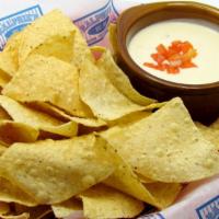  Queso Dip & Chips · Creamy queso cheese topped with diced tomato. Available with add-on of mexi meat or spicy ch...