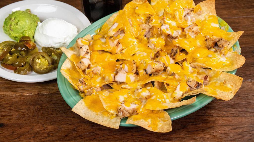 Deluxe Nachos · Tortilla chips topped with fajita beef or fajita chicken, refried beans, and Monterey Jack and cheddar cheese.