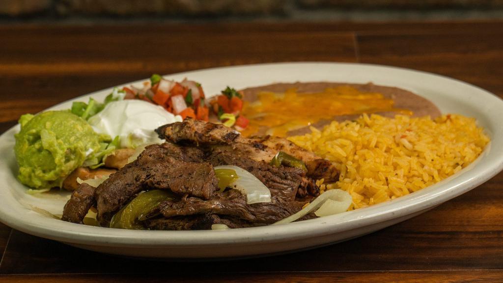 Fajita · Your choice of chicken, beef, sausage or mixed fajitas heaped with grilled bell peppers and onions, rice, refried beans, sour cream, guacamole, and pico de gallo.