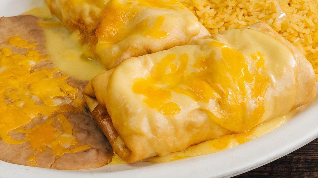 Chimichanga · Two fajita beef or fajita chicken chimichangas filled with cheese and fried to perfection topped with your choice of sauce served with rice and beans.