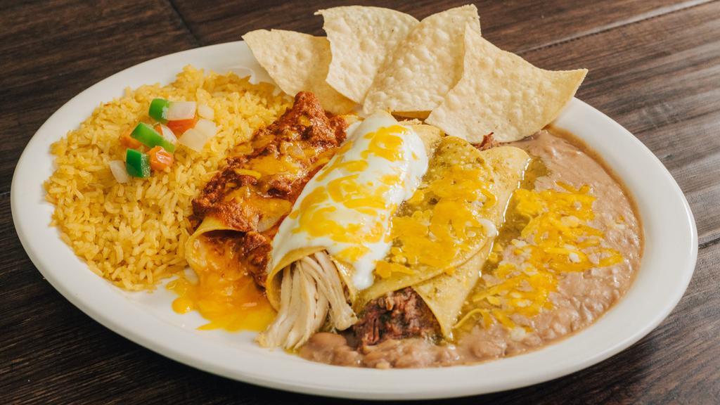 Bandera Mexicana · One shredded beef enchilada with green tomatillo sauce, one shredded chicken enchilada with sour cream sauce, and one cheese enchilada with chili sauce served with rice and beans.