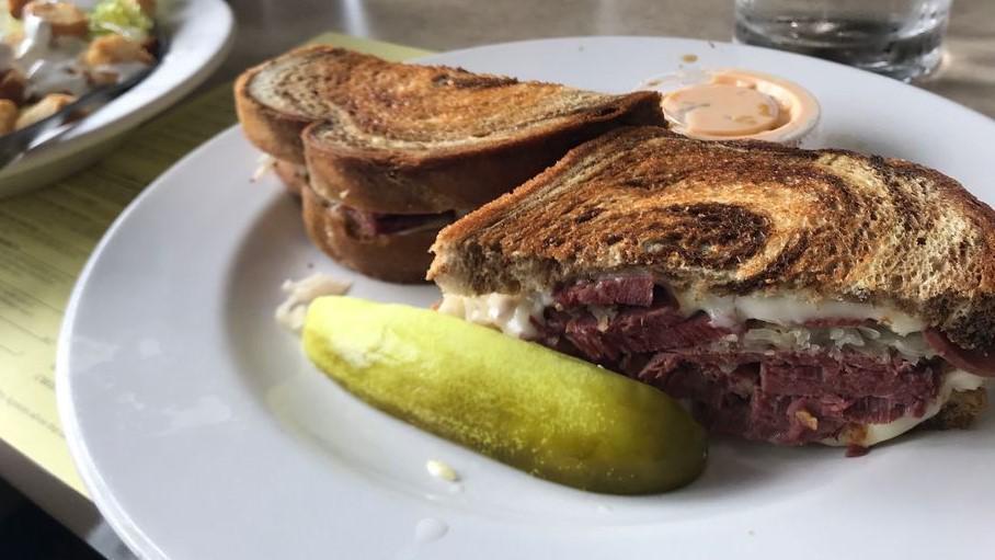 Reuben · Thick sliced corned beef, Swiss cheese and sauerkraut on grilled marble rye bread with thousand island dressing on a side.