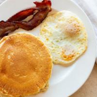 Pancakes And Eggs · Includes two cage-free eggs and two pieces of meat (bacon or sausage). Served with maple syr...
