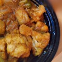 Aloo Gobi · Cauliflower and potatoes tossed in onion sauce with Indian herbs and spices, served with rice.