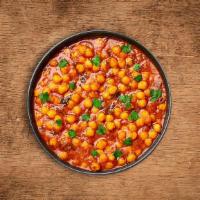 Savory Chickpeas Masala · Chickpeas and diced potatoes cooked in onion and tomato curry with Indian whole spices. Serv...