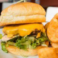 Woody Burger · American Cheese, shredded Iceberg lettuce, house pickles, and comeback sauce, served on a po...