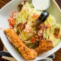 The Woodbury Salad · Iceberg wedge, crispy Chicken tenders, avocado, tomato, white cheddar cheese, bacon and chiv...