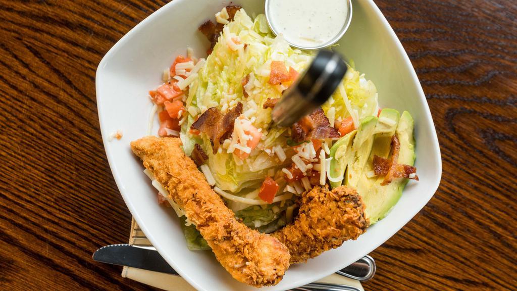 The Woodbury Salad · Iceberg wedge, crispy Chicken tenders, avocado, tomato, white cheddar cheese, bacon and chive ranch