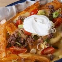 Nacho Fries · French fries topped with ground beef, guacamole, pico de gallo, shredded cheese and sour cre...