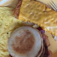 Hungry Man · Two eggs, hash browns, three strips of bacon, two sausage patties and toast. Add two pancake...