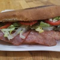 Torta De Jamon · Pork Ham Mexican Sandwich Accompanied with beans, avocado, lettuce, chili pepper slices, tom...