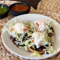 Sopes · Three crispy homemade corn shells, served with beans, lettuce, onion, tomato, cheese, and so...