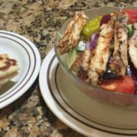 Grilled Chicken Salad · With tomatoes, onions, cheese and hard boiled egg and pita bread.