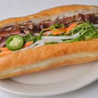 Baguette Sandwich | Banh Mi · Grilled marinated pork in a French baguette with pickled daikon/carrots, jalapeno peppers an...