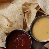 Chips & Dips · Tortilla chips with salsa and choice of cheese sauce.