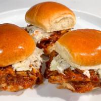 Pulled Pork Sliders · Three sliders piled high with 18-hour smoked pulled pork, Smokeheads Texas Mop BBQ Sauce, pi...