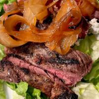Steak Salad · Spring mix tossed in our house vinaigrette, caramelized onions, bleu cheese crumbles, fried ...