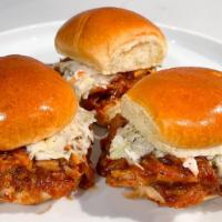 Pulled Pork Sliders · Three sliders piled high with 18-hour smoked pulled pork, Smokeheads Texas Mop BBQ Sauce, pi...