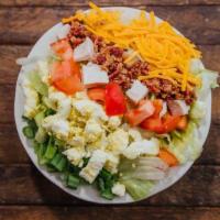 Cobb Salad (Small) · Iceberg lettuce topped with diced turkey breast, diced tomatoes, shredded Colby cheese, baco...