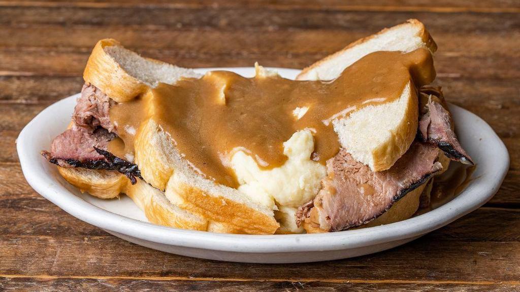 Beef Manhattan · Tender, hand-carved roast beef sandwich topped with mashed potatoes and homemade brown gravy.