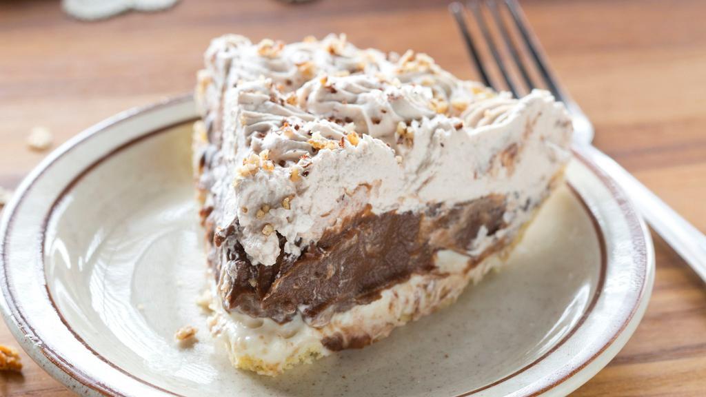 Chocolate Pudding Nut · Layer of cream cheese mixture covered with pecans and chocolate filling, topped with whipped cream and sprinkled with pecans.