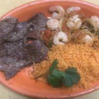 Plato De Camaron/Shrimp Plate · the mexican shrimp plate comes with rice and tortilla on the side also has a piece of steak.