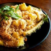 Pineapple Fried Rice · Authentic Thai fried rice stirred with fresh. pineapple, carrots, peas, corn, egg and onions...