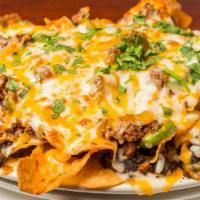 Lighthouse Nachos · Layers of fried tortilla chips, melted shredded cheese, seasoned beef, black beans, jalapeno...
