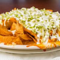 Buffalo Chicken Nachos · Layers of fried tortilla chips, smothered with cheese sauce, buffalo chicken slices, jalapen...