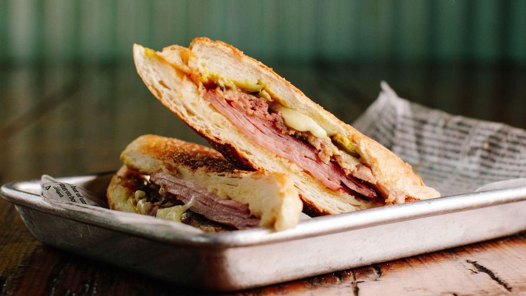 Cubano By 90 Miles Cuban Cafe · By 90 Miles Cuban Cafe. Ham, roast pork, Swiss cheese, pickle, and mustard. Contains gluten and dairy. We cannot make substitutions.
