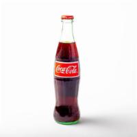 Mexican Coke · 12 oz glass bottle of Coke, sweetened with real cane sugar and imported from Mexico.