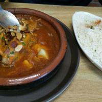 Spicy Lamb Tagine · Spicy, popular. Slow cooked lamb shank in jalapenos sauce topped with roasted almonds and dr...