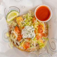 Tostadas · Flat shell topped with beans, meat, cheese, lettuce tomato, sour cream.