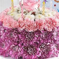 Birthday Wishes Flower Cake - Large · Flower cake is decorative only; DO NOT EAT.

3-D cake-shaped floral arrangement with pink mi...