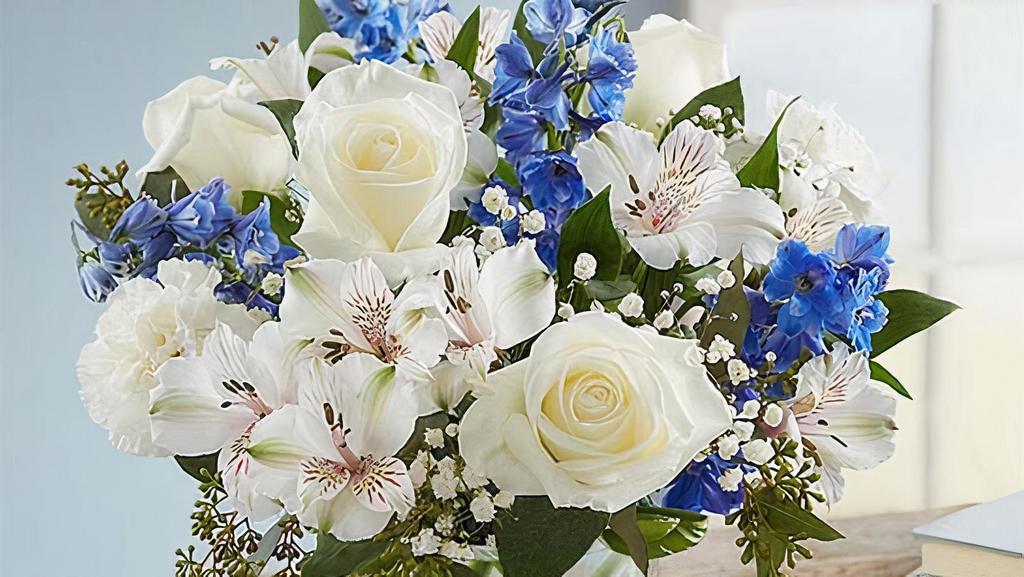 Wonderful Wishes Bouquet · Our rustic, easy bouquet in shades of blue and white captures every wish you want to express to those who mean the most. Hand-designed
arrangement with white roses, carnations, and Peruvian lilies (alstroemeria); blue delphinium; baby’s breath; seeded eucalyptus, and assorted greenery.
Peruvian lilies may arrive in bud form and will open to full beauty in 2-3 days; 
Medium arrangement measures approximately 13