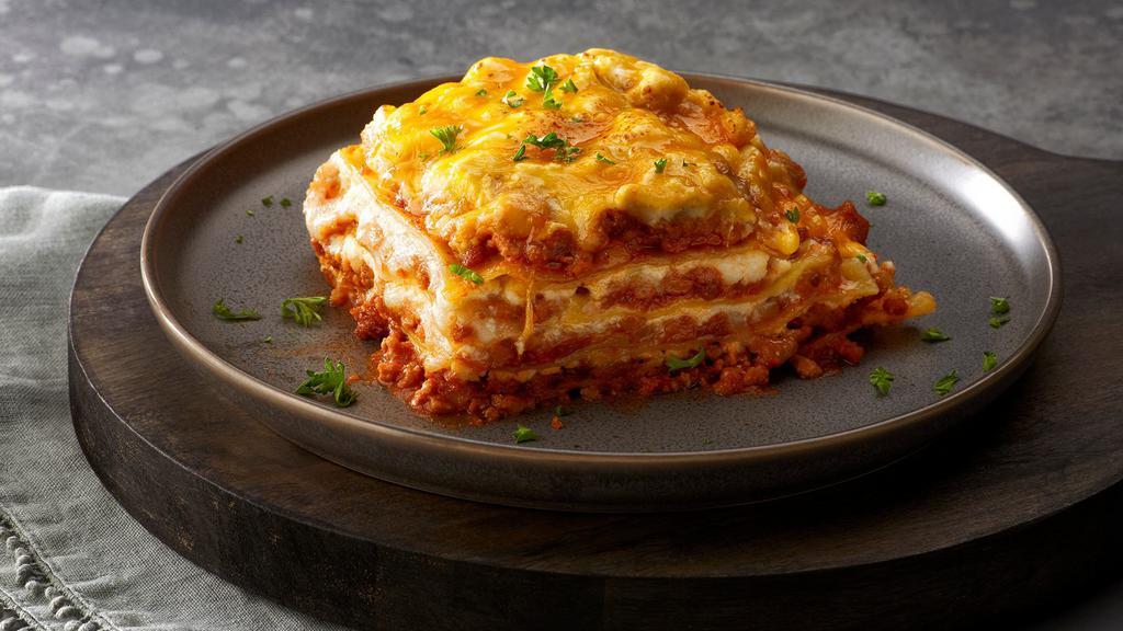 Lasagna Bolognese · Hearty Bolognese with Italian sausage, ground beef, creamy ricotta, freshly shredded mozzarella log and basil.