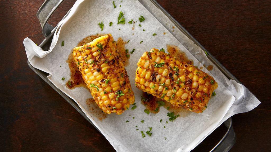 Grilled Buttered Street Corn · Grilled Cob sweet corn with house creole spice, butter and parsley.