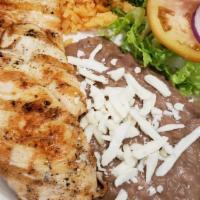 Grill Chicken · GRILL CHICKEN BREAST SERVED WITH RICE AND BEANS.