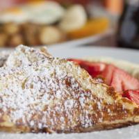 French Toast · Two slices cooked to golden brown perfection with warmed syrup.